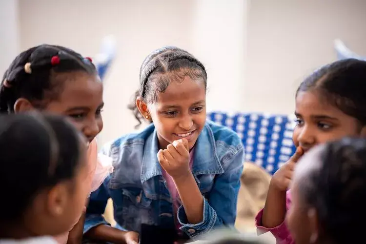 Photo of 5 students in a discussion